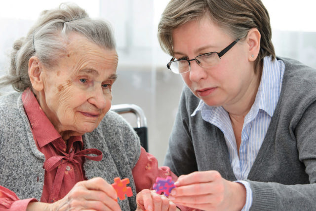 Staff Assisting Memory Care Patient